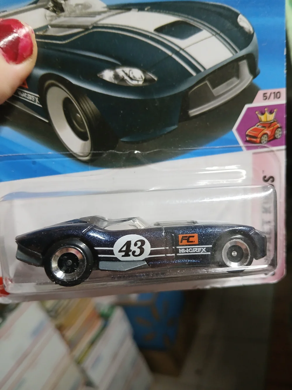 dark blue Hot Wheels RRROADSTER from the Compact Kings series features white rac